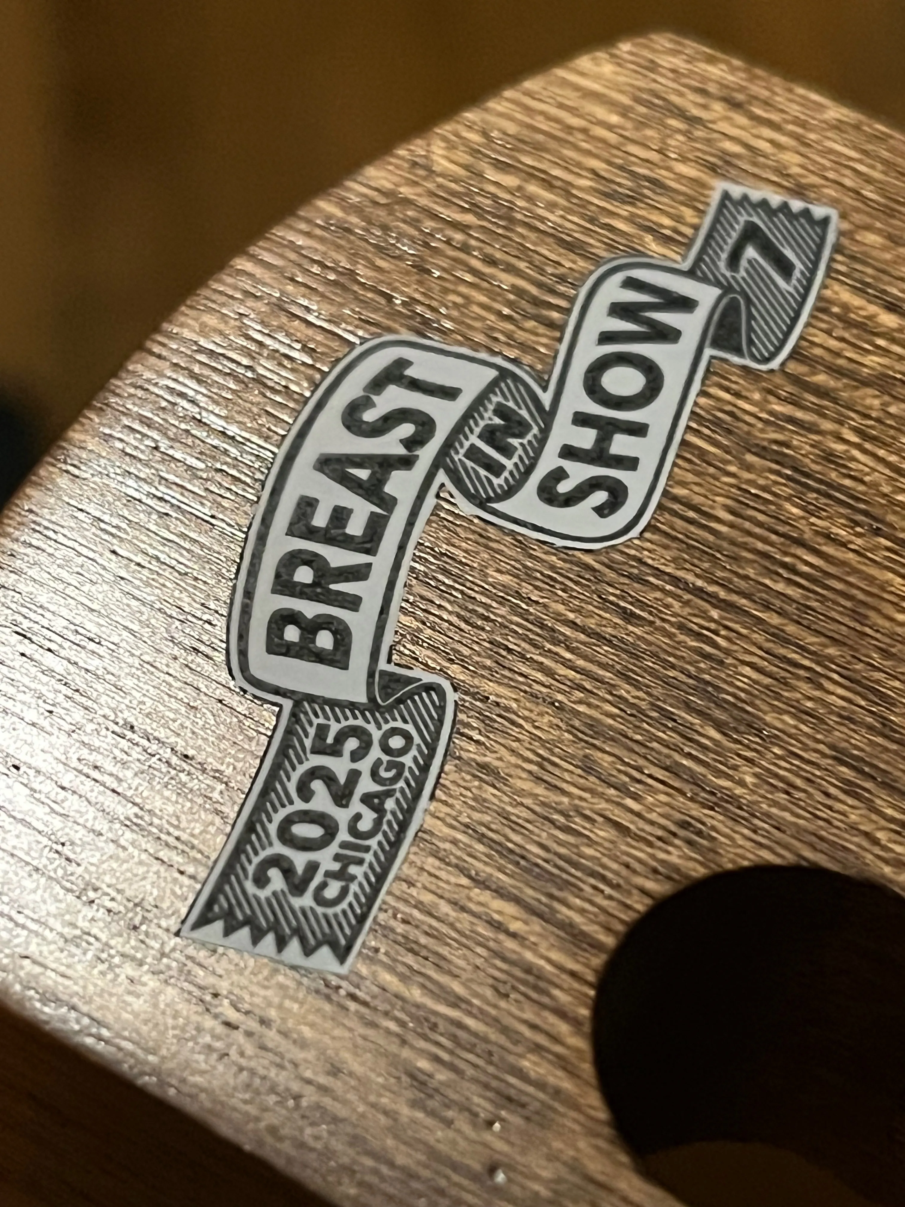 "Breast in Show 7" decal on a lap steel head